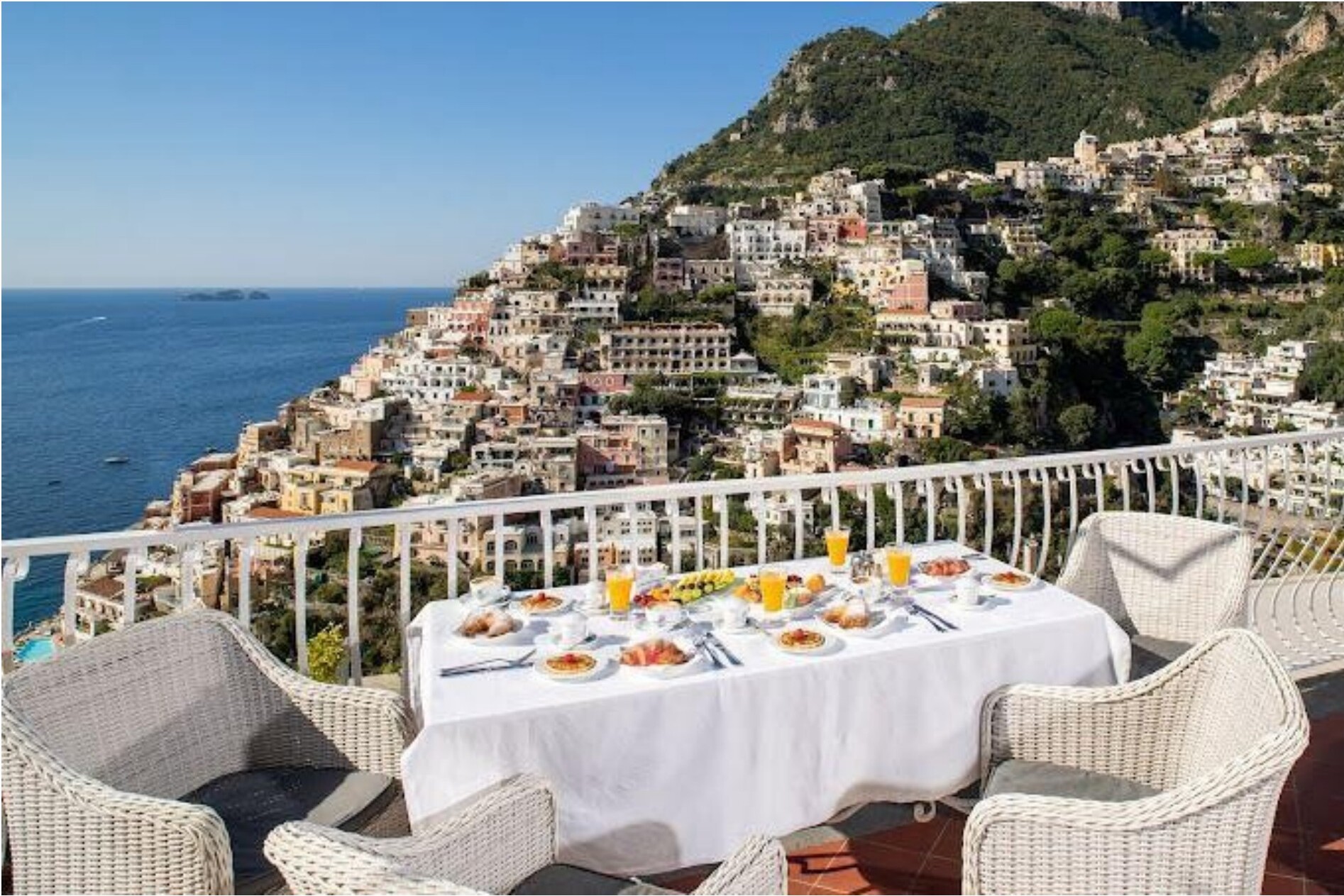 Breakfast table on a terrace overlooking the coast.